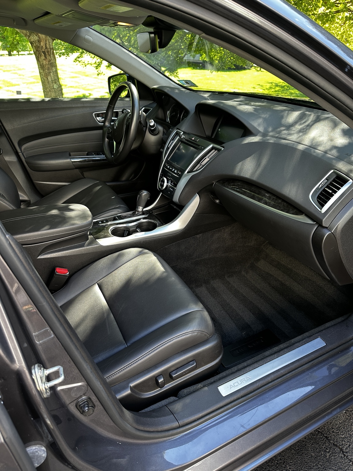 Freshly detailed Acura interior with clean black leather seats, dashboard, and carpets